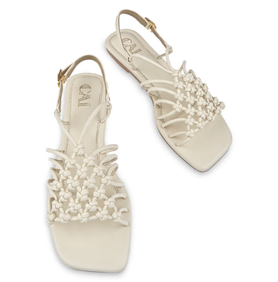 Cream puzzled flats